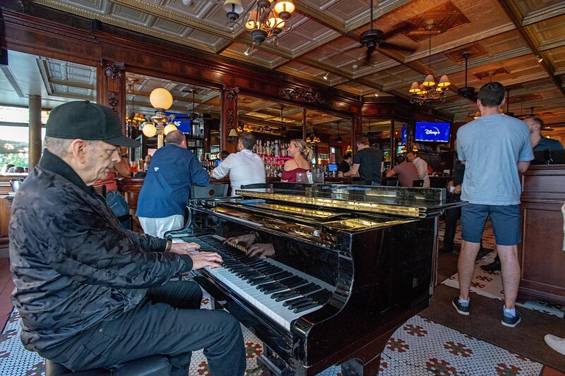 Piano player and customers at bar area